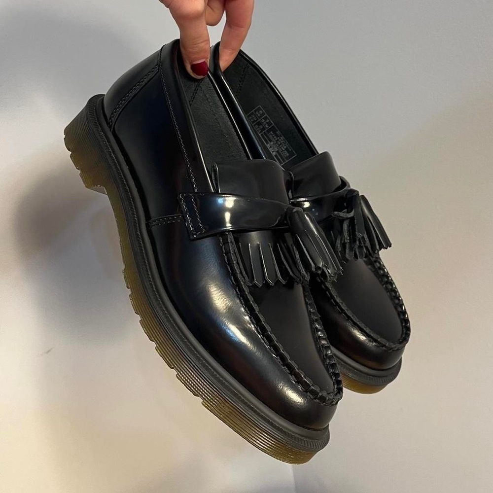 Dr. Martens Adrian tassel loafers in black polished smooth leather.